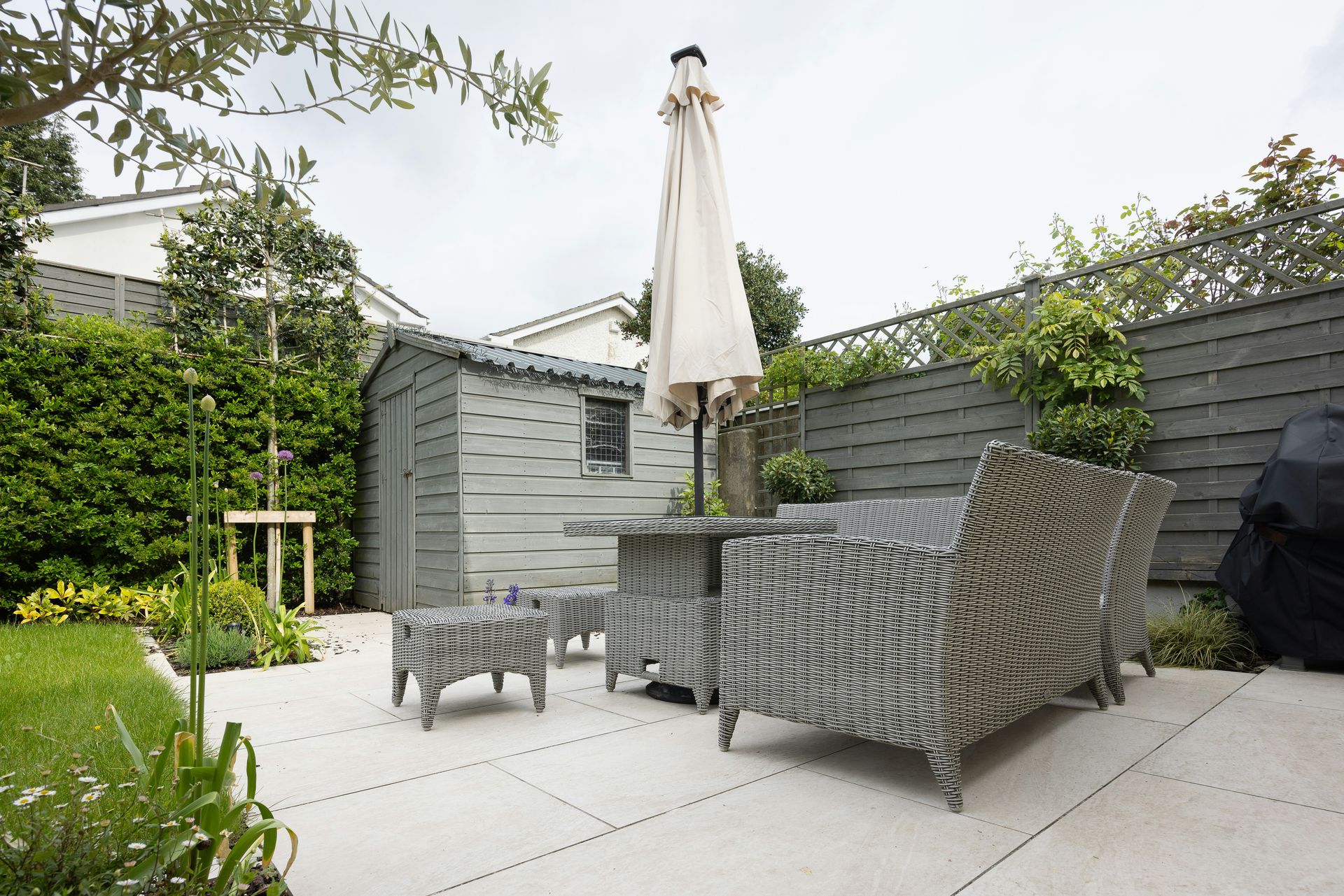 A patio with a table and chairs and an umbrella