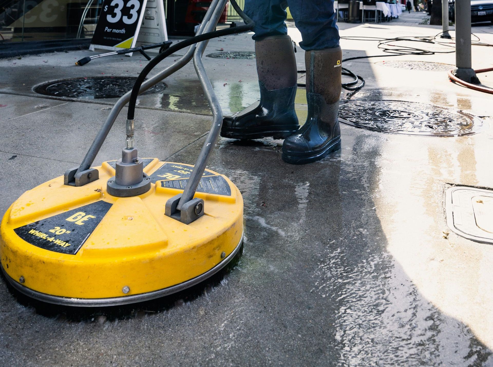 a man in a yellow vest is cleaning the street