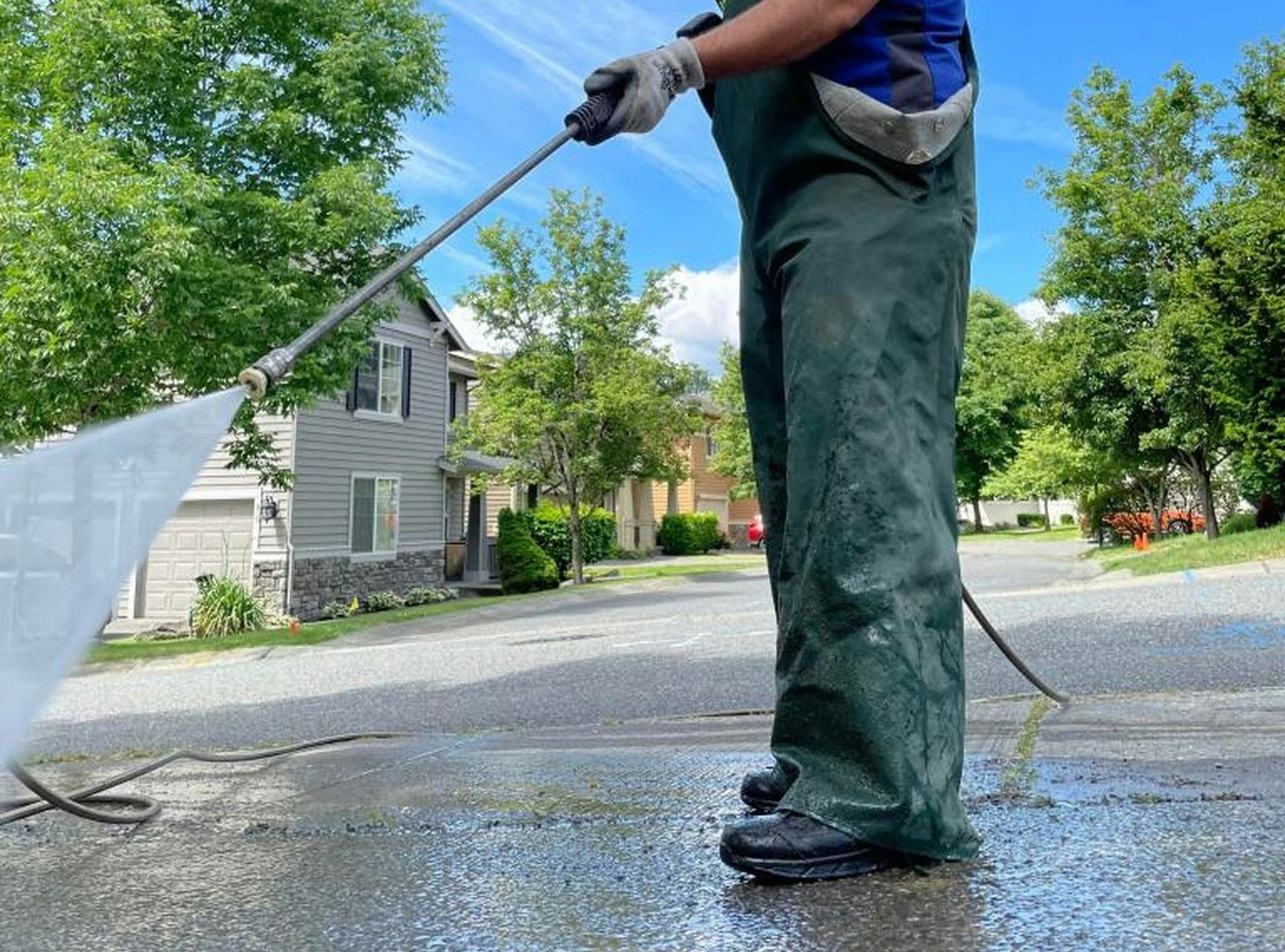 a man is cleaning the street with a hose